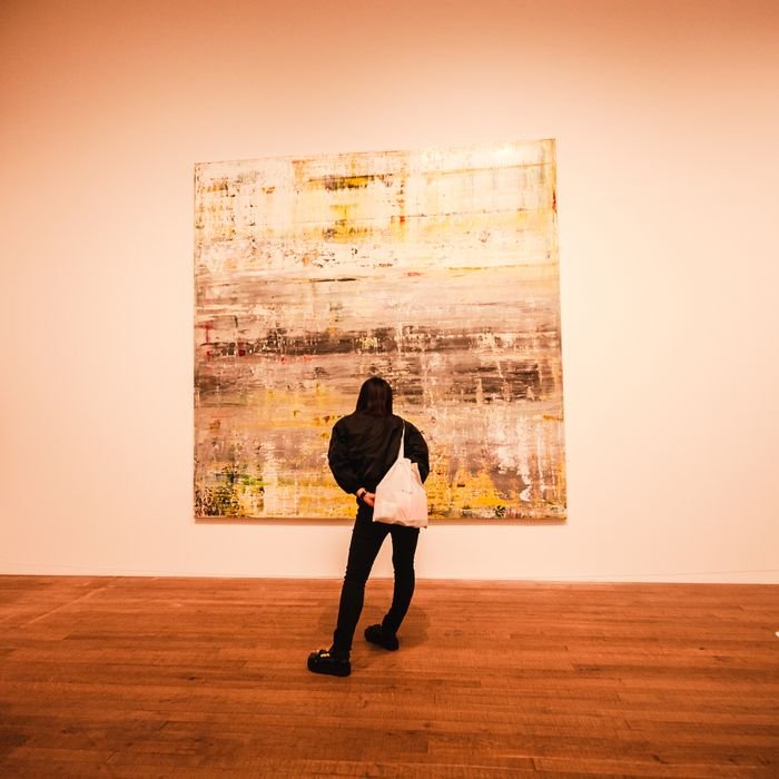 A person observes an abstract painting in a London art gallery, capturing a moment of creativity and inspiration.